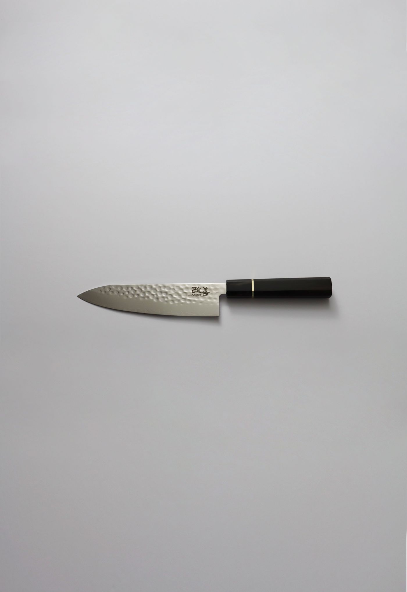 Kaizen gyuto chef knife with hammered damascus blade and black ebony handle